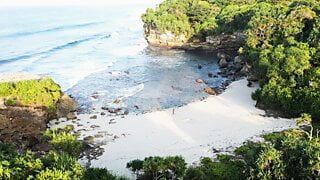 Putri Cinta stripping on a beautiful tropical beach