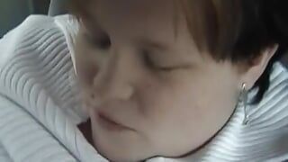 A chubby German lady enjoys sucking a hard cock in the back of the car
