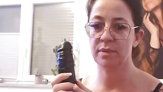 Tattooed brunette with glasses plays with her tampoo