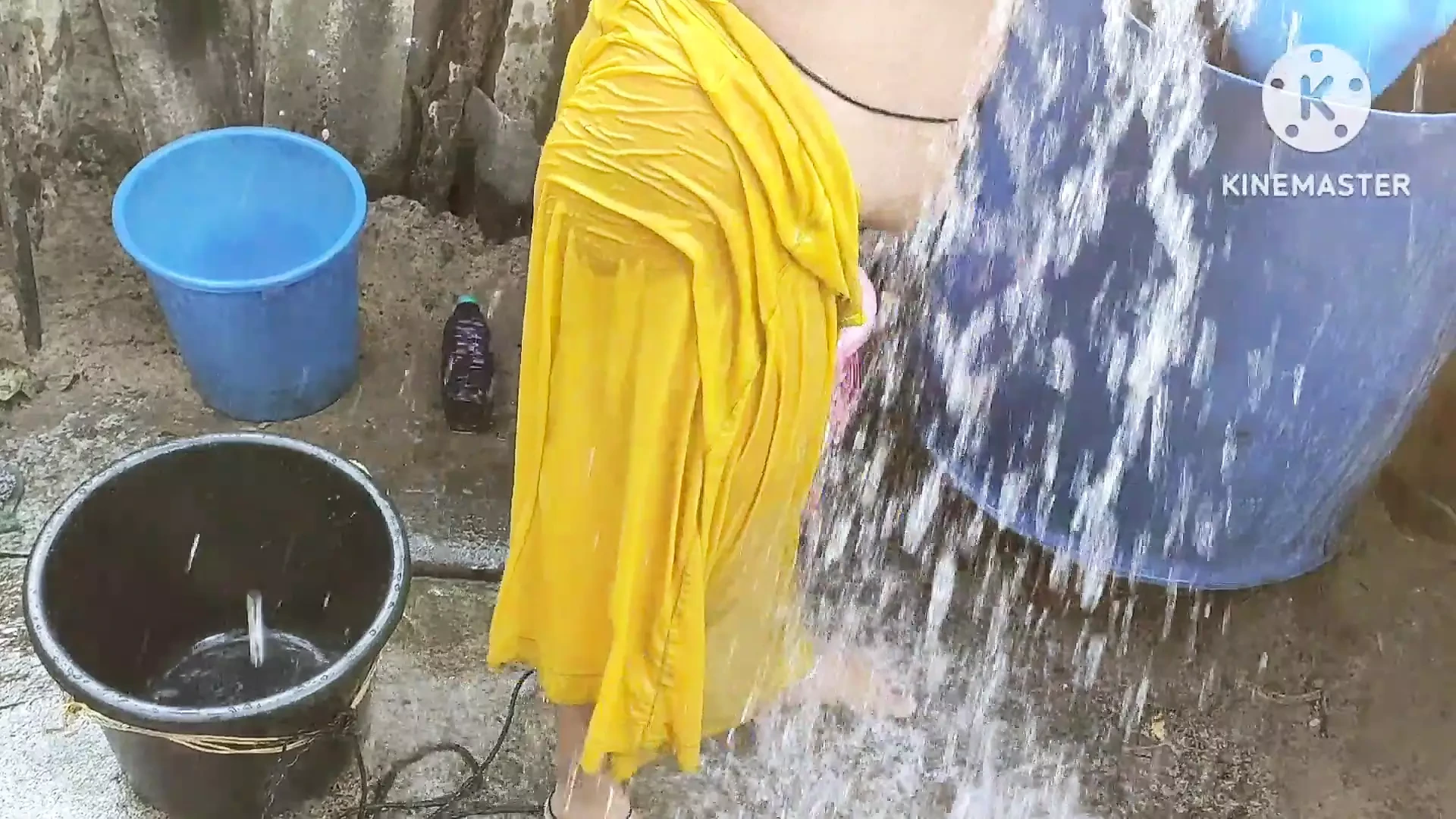 Indian house wife bathing outside