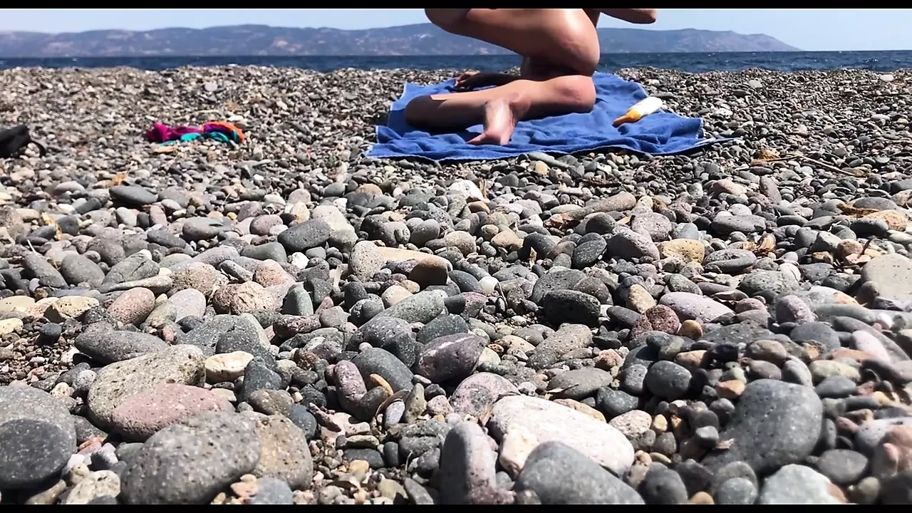 Cute exhibitionist girl get naked in public beach