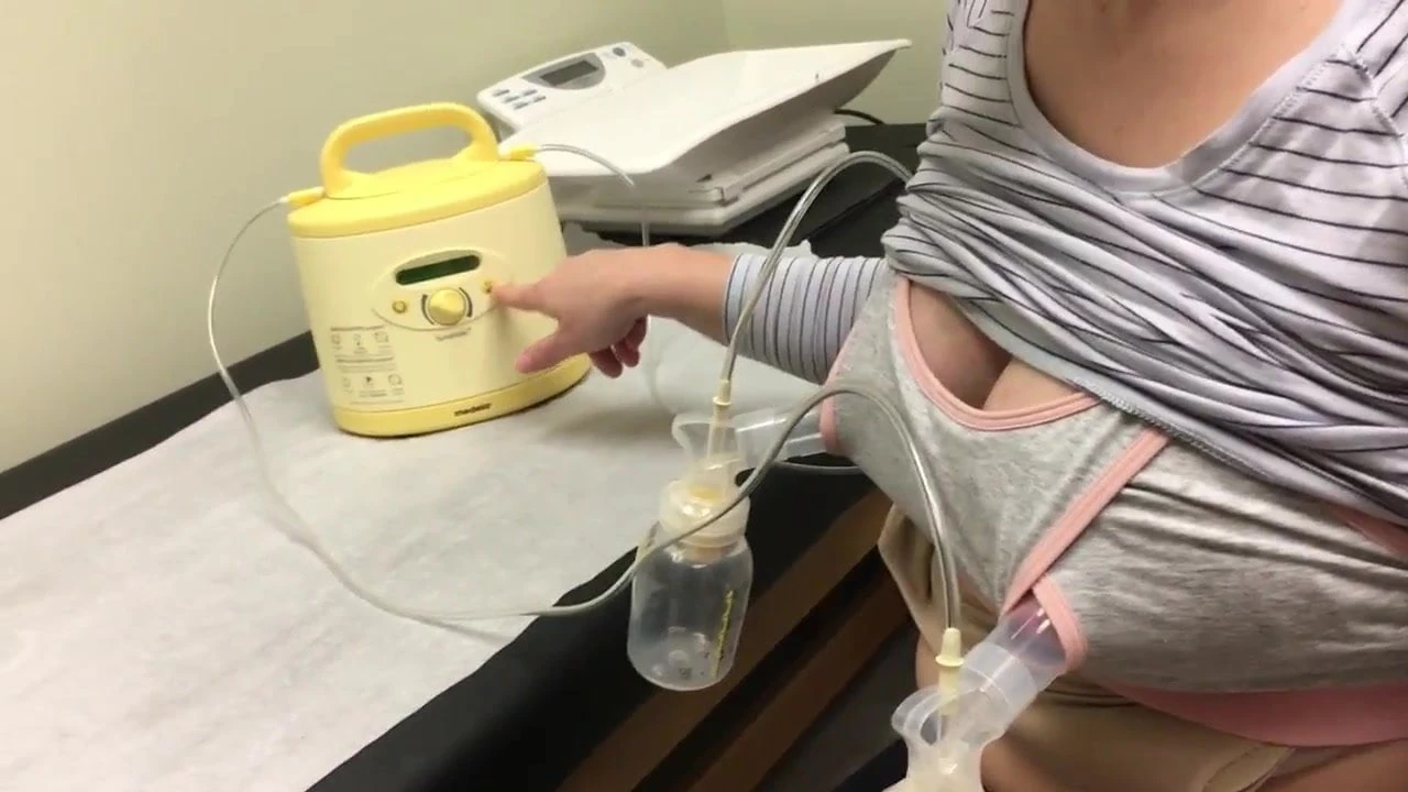 Pumping milk from tits in nursing bra