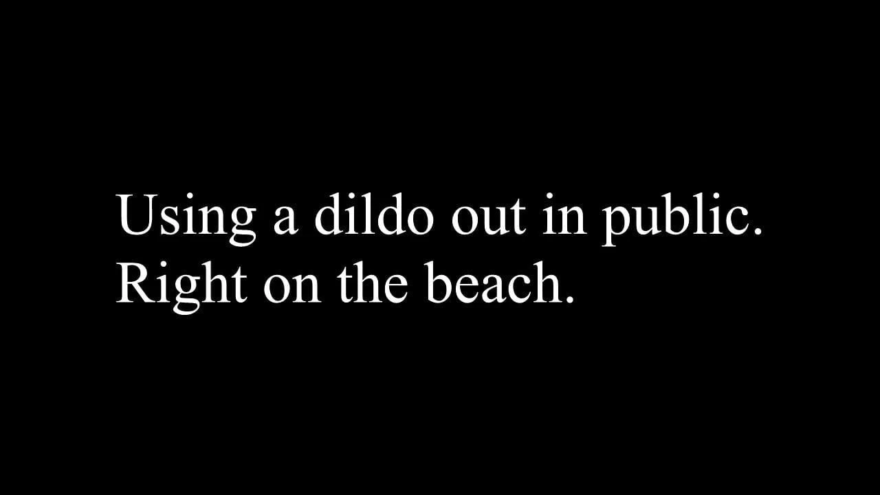 Using a dildo on the beach.