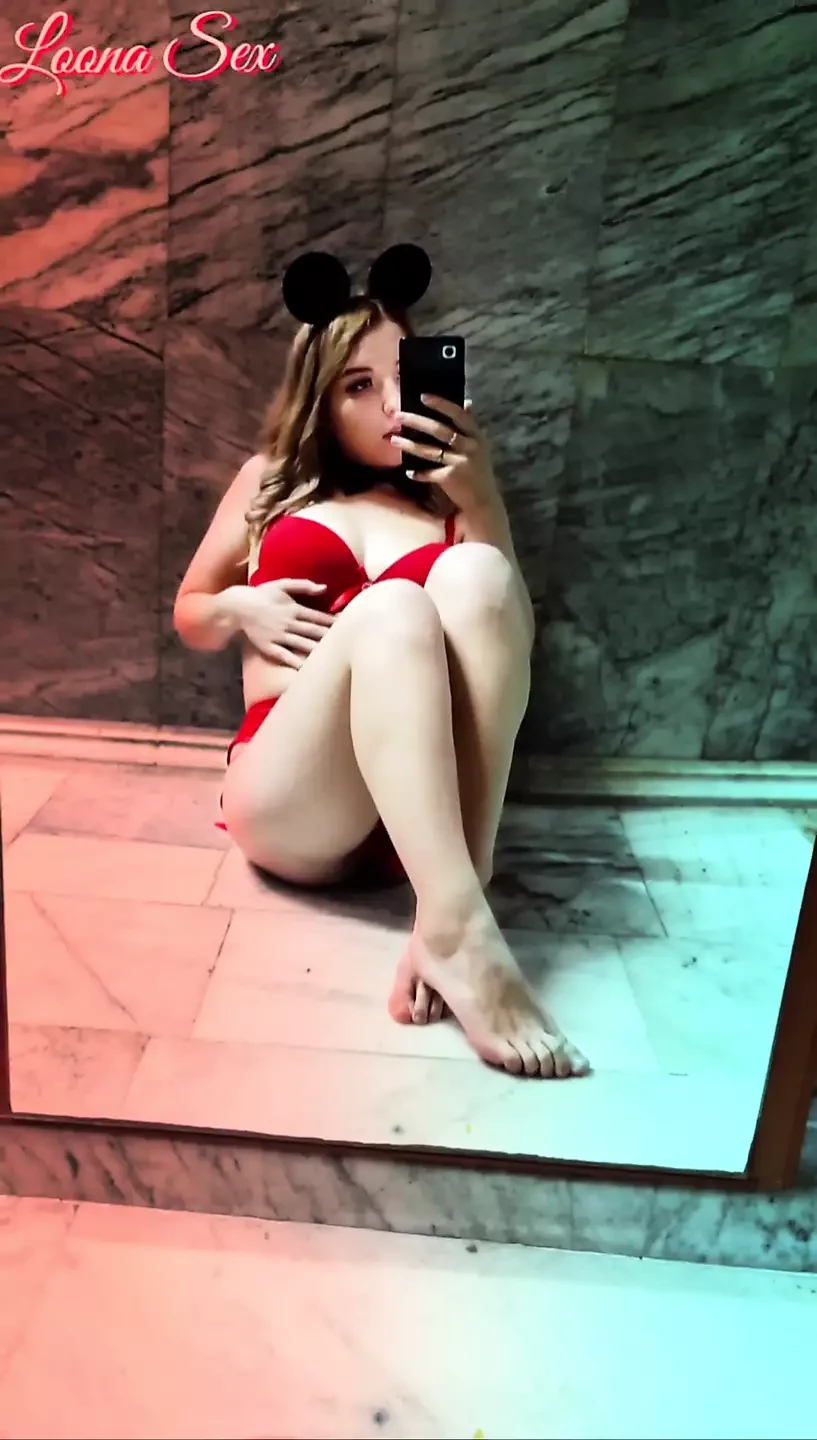 Young girl her in front of the mirror