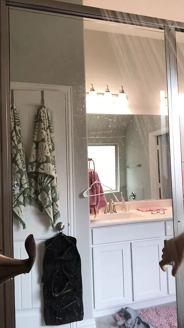 Curvy woman in a hot shower