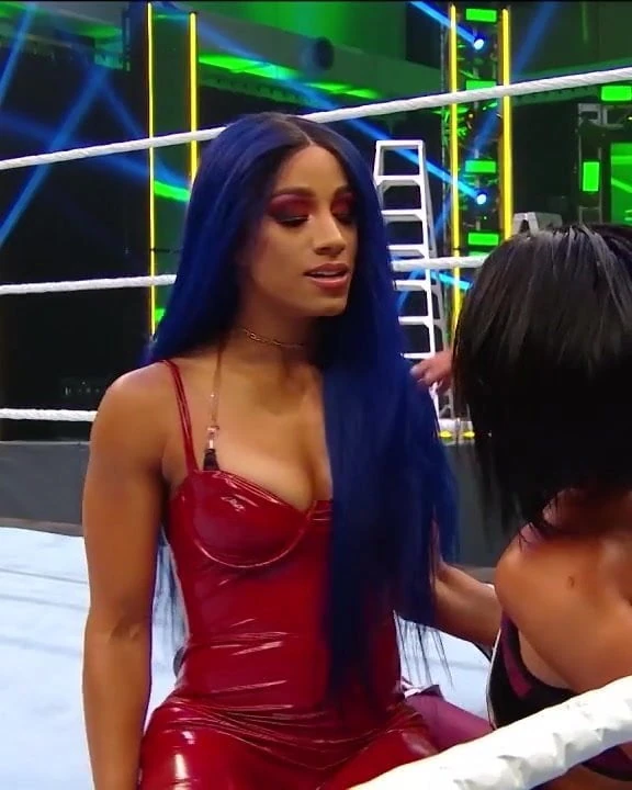 WWE – Sasha Banks in hot red outfit looking out for Bayley